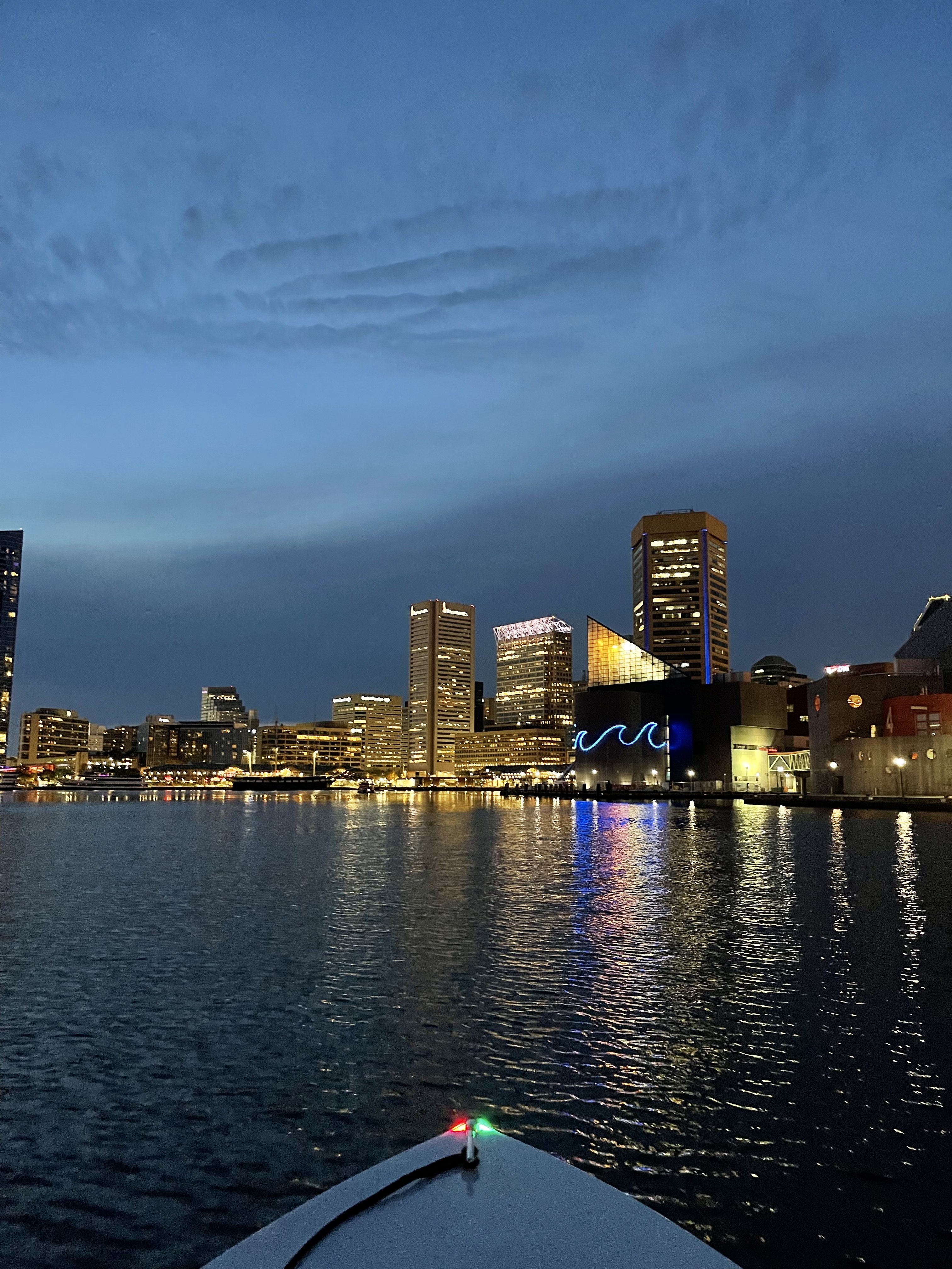 Baltimore's Inner Harbor lit up at night as seen from the water on a Yachtsy cruise