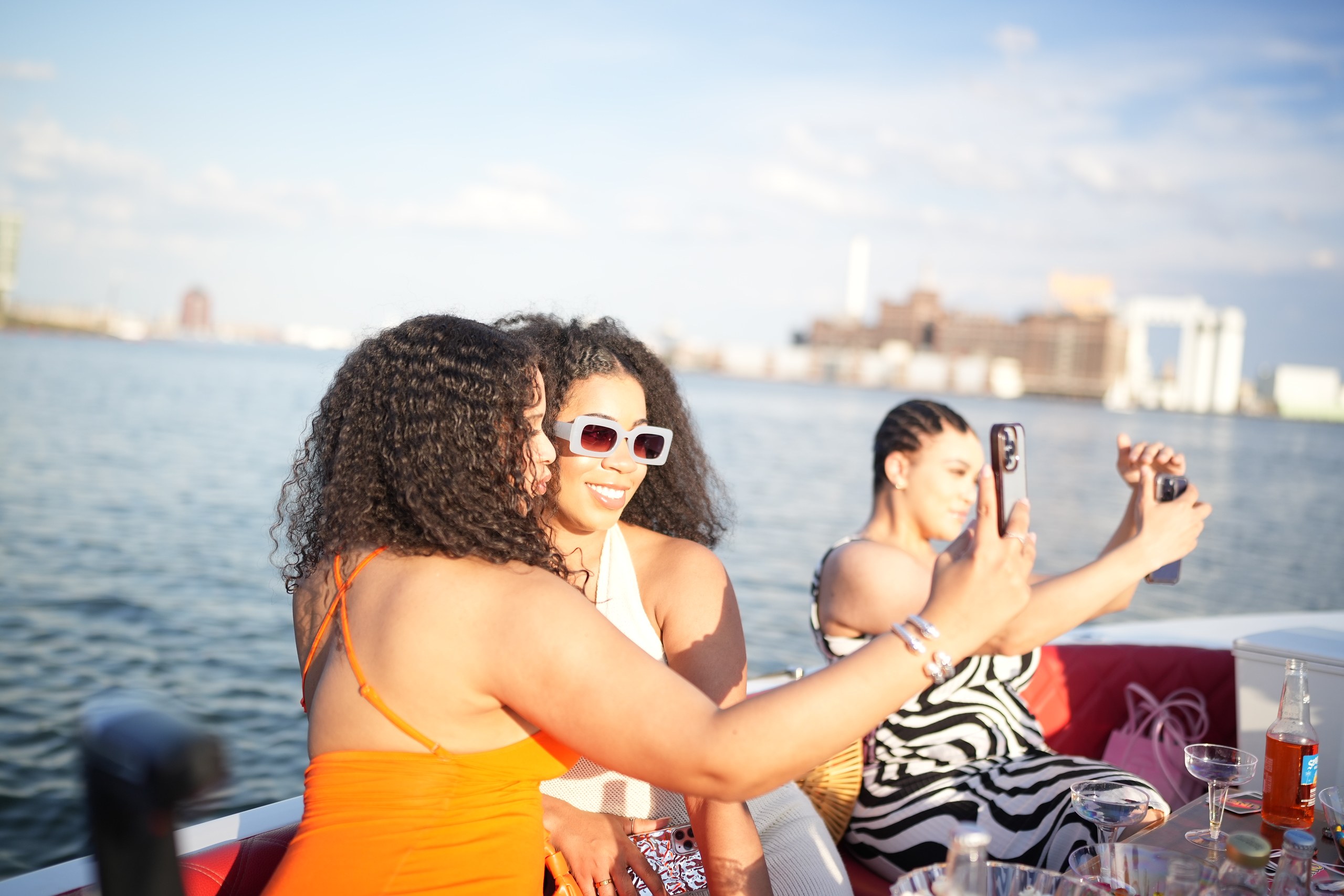Guests having fun and taking photos on a private Yachtsy cruise in Baltimore's Inner Harbor
