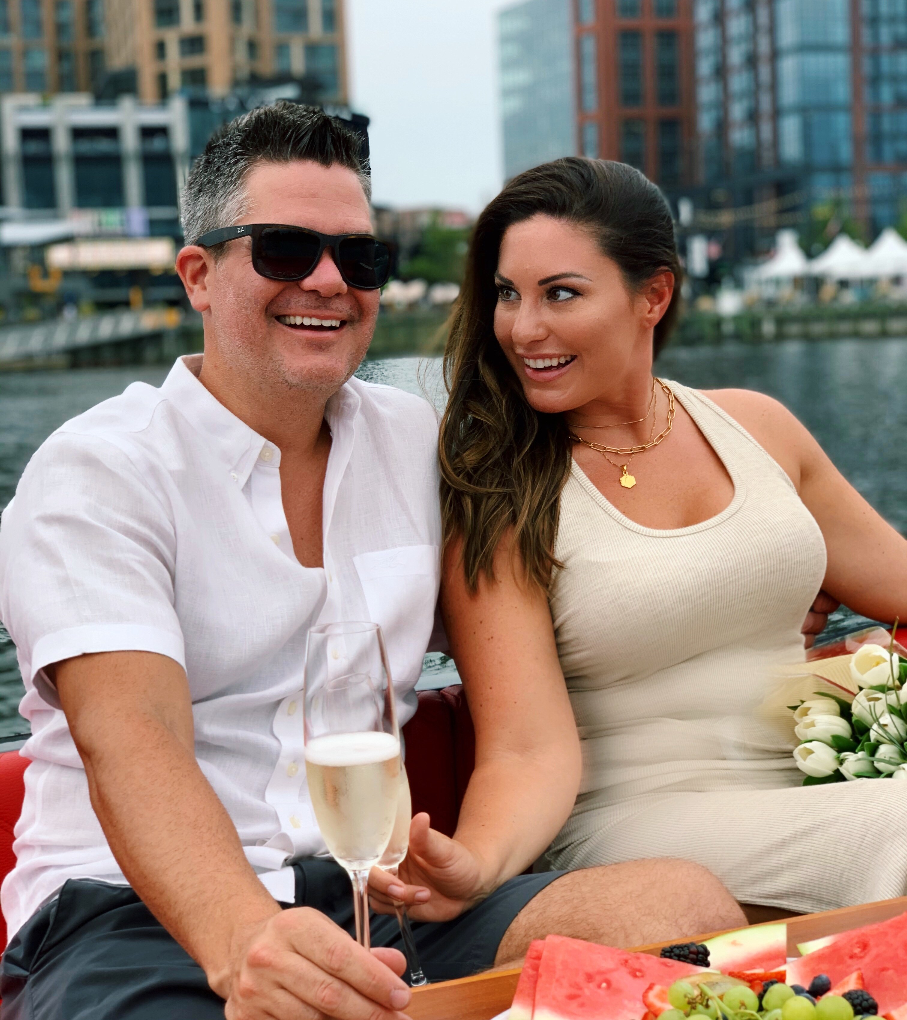 A couple enjoying a private sunset date night cruise aboard a Yachtsy picnic boat